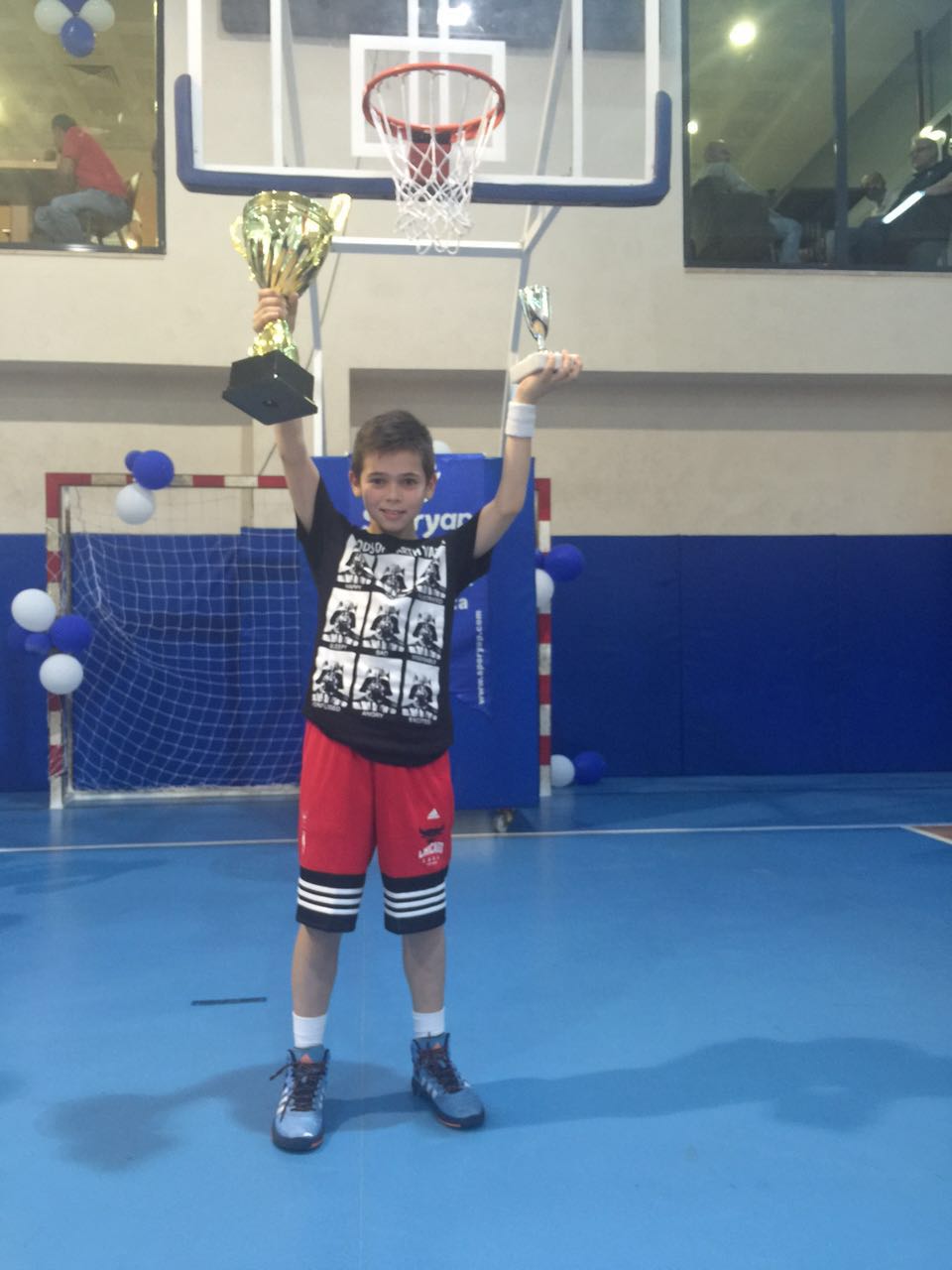 Young Efe lifting championship trophies during the Istanbul foundation years